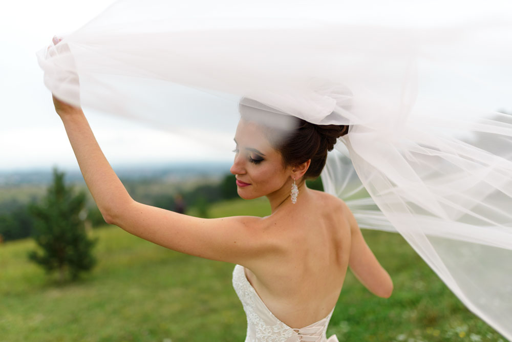 bride under a veil. The wind blows